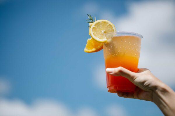 Plastic Cup Tequila Sunrise with Lemon and Orange Slices